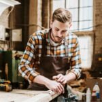 selective focus of bearded woodworker holding chis q38kgje 1